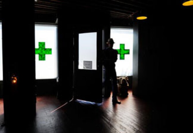 A client enters Sunset Junction medical marijuana dispensary in Los Angeles, California.  