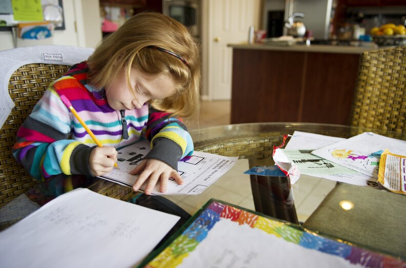Autumn Watson does her homework in her dining room in Centreville, Maryland after class at Centreville Elementary on April 30, 2013