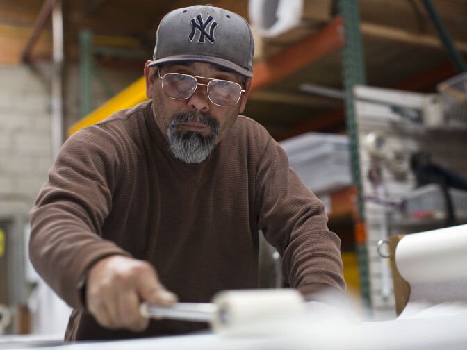 Epiganio Guzman, a welder at JCL Traffic, helps out with an order of 500 street signs for South El Monte on Friday, Jan. 9.