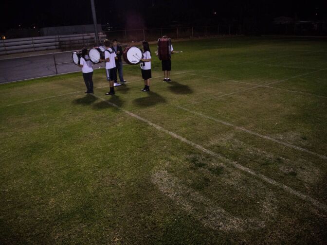 The bass drum line of the South Hills High School Marching Band warms up at the beginning of practice.
