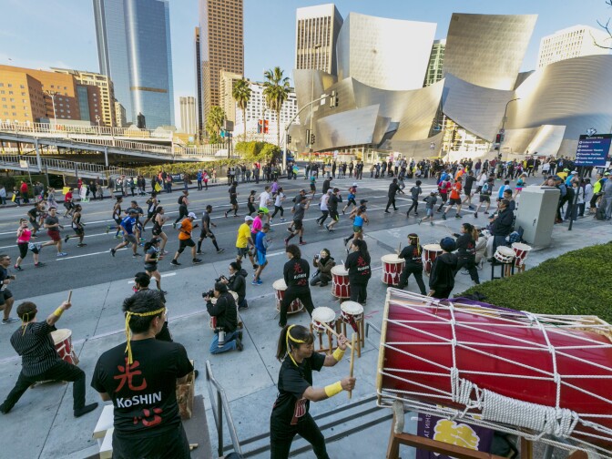 Members of the Venice Koshin Taiko drumming ensemble perform for Los Angeles Marathon runners as they race past the Walt Disney Concert Hall in Los Angeles Sunday, March 18, 2018. 