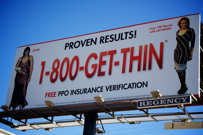 A billboard claiming that a patient "lost 100 pounds with Lap-Band."