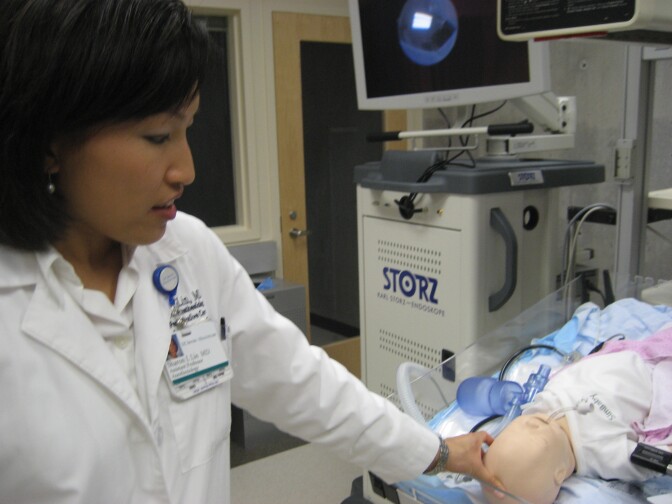 Dr. Sharon Lin, director of UC Irvine's new Medical Education Simulation Center, points out some features on a pediatric mannequin in the lab.