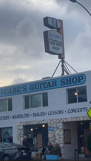 Exterior shot of McCabe's Guitar Shop set against a cloudy backdrop.