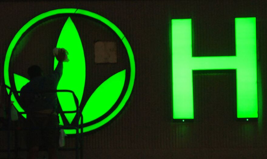 A worker cleans the logo on the Herbalife sign as finishing touches are put on the company's building in Torrance, Calif. Herbalife came out swinging Thursday, Jan. 10, 2013 against claims made by hedge fund manager William Ackman that the business amounts to a pyramid scheme.  