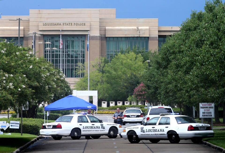 Law enforcement officers block the entrance to the Louisiana State Police headquarters after 3 police officers were killed early this morning on July 17, 2016 in Baton Rouge, Louisiana. 
