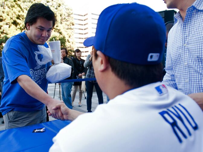 Desmond Meza of Los Angeles shakes hands with the left-handed pitcher.