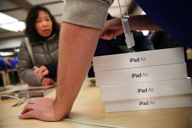 Apple employees sell the new iPad Air at the Apple Store on November 1, 2013 in New York City. The new iPad, which will also come in a mini version and is the fifth generation of the popular tablet, is 20% thinner and 28% lighter than the current fourth-generation iPad. It has the same 9.7-inch screen as previous iPads and uses the same A7 processing chip that's in the iPhone 5S. The iPad Air, which went on sale today, will start at $499 for a 16GB Wi-Fi-only model and go up to $629 for a 16GB with 4G LTE connectivity.