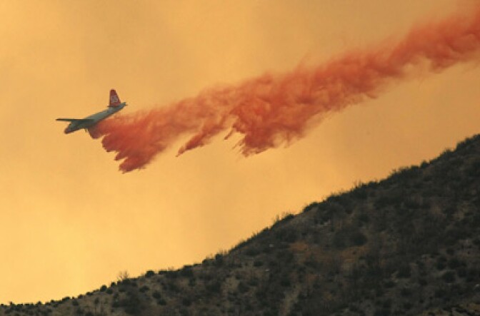 An air tanker drops fire retardant on a ridge ahead of a fast moving fire in the Angeles National Forest August 30, 2009 near Acton.