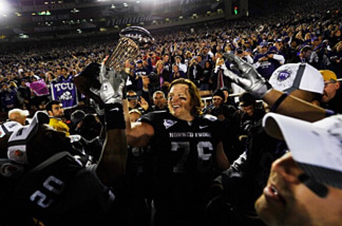 Center Jake Kirkpatrick #76 of the TCU Horned Frogs celebrates with the Rose Bowl Championship Trophy after defeating the Wisconsin Badgers 21-19 in the 97th Rose Bowl game.