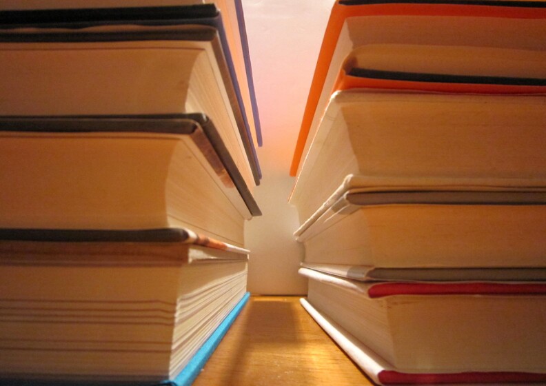 Two stacks of four books with their spines outside of the picture.