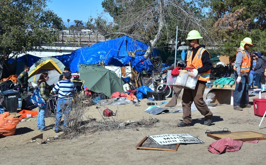 County workers clear and raze a homeless encampment beside the Santa Ana River on February 20, 2018 in Anaheim, California.
Officials in Orange County began moving homeless transients out of the homeless tent encampments to shelters or motels as part of the settlement worked out by homeless advocates and the county under supervision of a federal court judge. / AFP PHOTO / Frederic J. BROWN (Photo credit should read FREDERIC J. BROWN/AFP/Getty Images)
