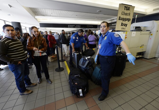 LOS ANGELES, CA - NOVEMBER 2: Transportation Security Administration workers screen luggage in Terminal 2 of Los Angeles International Airport as travelers start arriving for their flights a day after a shooting that killed one TSA agent November 2, 2013 in Los Angeles, California. A man pulled an assault rifle and shot his way through security at Terminal 3, killing one Transportation Security Administration worker, wounding several others. Federal officials identified the alleged gunman as Paul Ciancia, 23, of New Jersey.  (Photo by Kevork Djansezian/Getty Images)