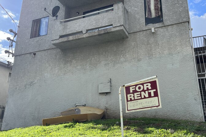 A "for rent" sign hangs outside an apartment building in the city of Los Angeles. 