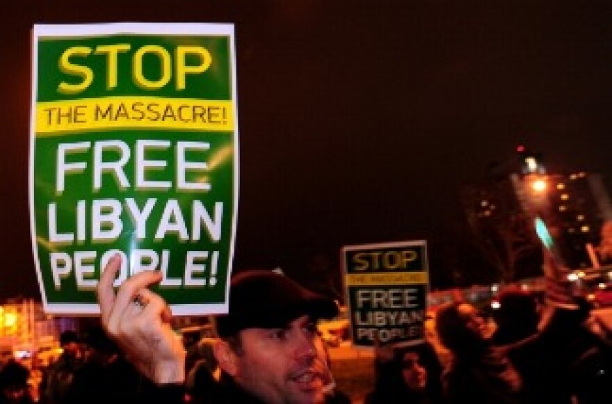 Demonstrators hold up a banners as they stage a protest outside the Libyan embassy in Istanbul on February 21, 2011.