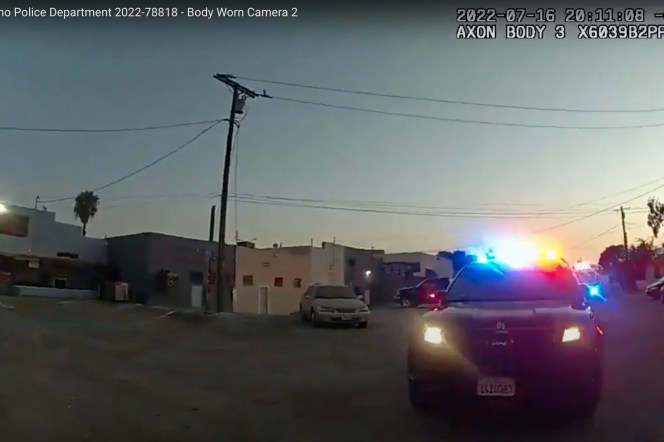 A police car is visible with lights flashing at dusk in a wide angle shot marked as body worn camera 2