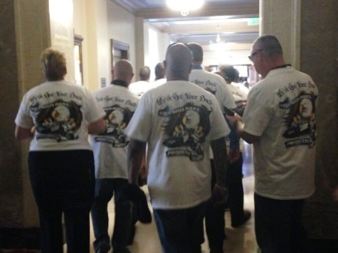 Police officers appeared in white T-shirts provided by the Los Angeles Police Protective League. 