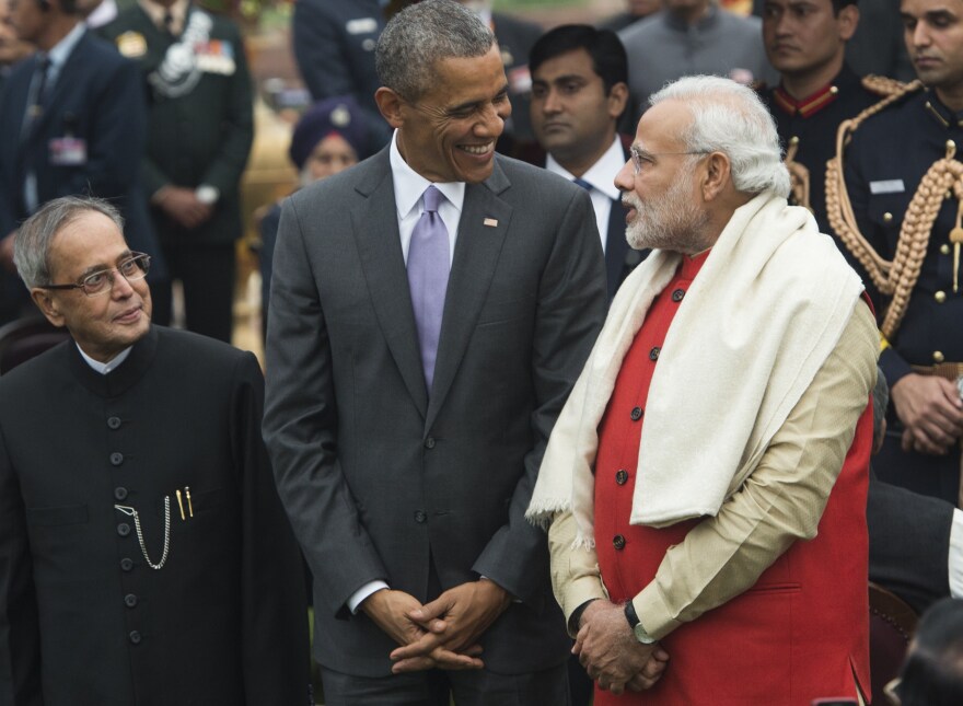 US President Barack Obama (C), Indian Prime Minister Narendra Modi (R) and Indian President Pranab Mukherjee (L) attend a reception at Rashtrapati Bhawan, the Presidential Palace, in New Delhi on January 26, 2015. Rain failed to dampen spirits at India's Republic Day parade January 26 as Barack Obama became the first US president to attend the spectacular military and cultural display in a sign of the nations' growing closeness. AFP PHOTO / SAUL LOEB        (Photo credit should read SAUL LOEB/AFP/Getty Images)