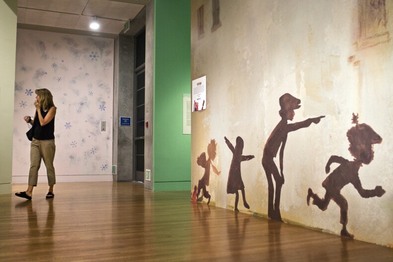 Attendees can mimic Keats-inspired silhouettes on the shadow wall at the end of "The Snowy Day" exhibit at the Skirball Cultural Center.