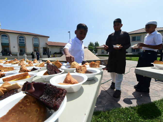 Children help themselves to bowls of assorted snacks, including Samosas and Chocolate cake, for the feasting while celebrating Eid al-Fitr, marking the end of fasting during the month-long Ramadan, at the Baitul Hameed Mosque in Chino, California on July 6, 2016. 

The Pew Research center estimated earlier this year there were about 3.3 million Muslims of all ages living in the United States in 2015.
 / AFP / Frederic J. BROWN        (Photo credit should read FREDERIC J. BROWN/AFP/Getty Images)