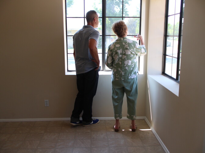 A Martinez and real estate agent Myra Elder survey a home in San Bernardino. 