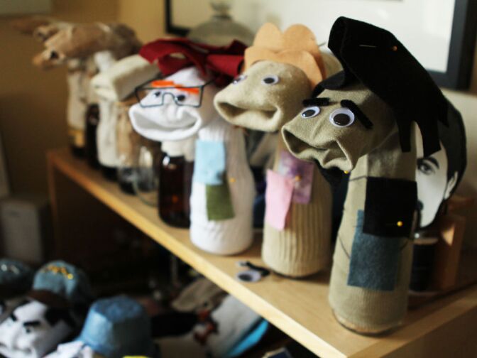 A row of sock puppets wait for costumes. 