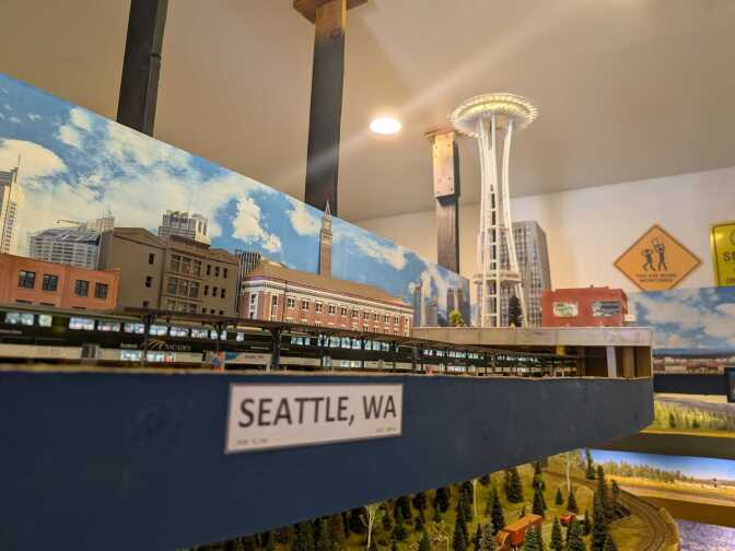 A model train layout with buildings and structures. A label "Seattle, WA" is affixed to it.