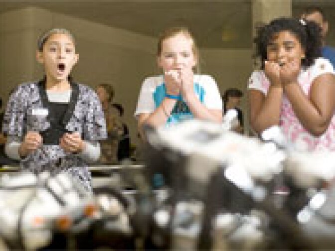 Students watch their robot, "DT Exterminator," fall in the competition