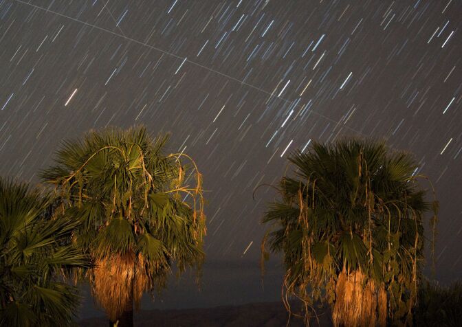 LAKE MEAD NRA, NV - AUGUST 12:  Perseid meteors streak across the sky early August 12, 2008 near Rogers Spring in the Lake Mead National Recreation Area, Nevada. The meteor display, known as the Perseid shower because it appears to radiate from the constellation Perseus in the northeastern sky, is a result of Earth's orbit passing through debris from the comet Swift-Tuttle. Tuesday morning was considered the peak of the shower, which is visible every August.  (Photo by Ethan Miller/Getty Images)