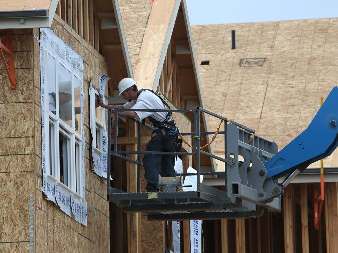 A measure of the U.S. economy's future health rose in solidly in April, buoyed by a sharp rise in applications to build new homes and apartments. The Conference Board index is intended to signal economic conditions three to six months out. (Photo: A construction worker installs a window in a new home at the Arbor Rose housing development  in San Mateo, California. Photo by Justin Sullivan/Getty Images)