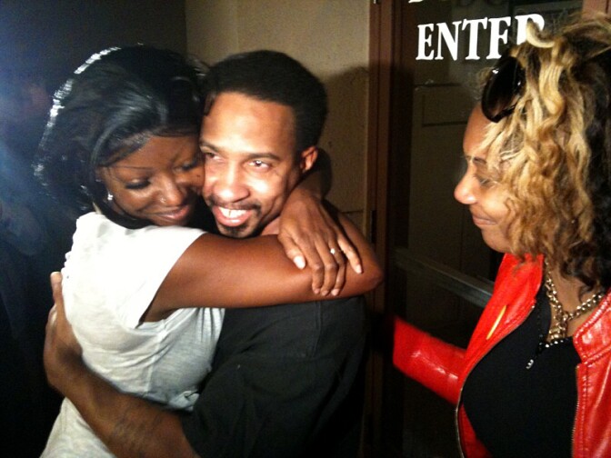 Obie Anthony hugging his wife with his sister looking on