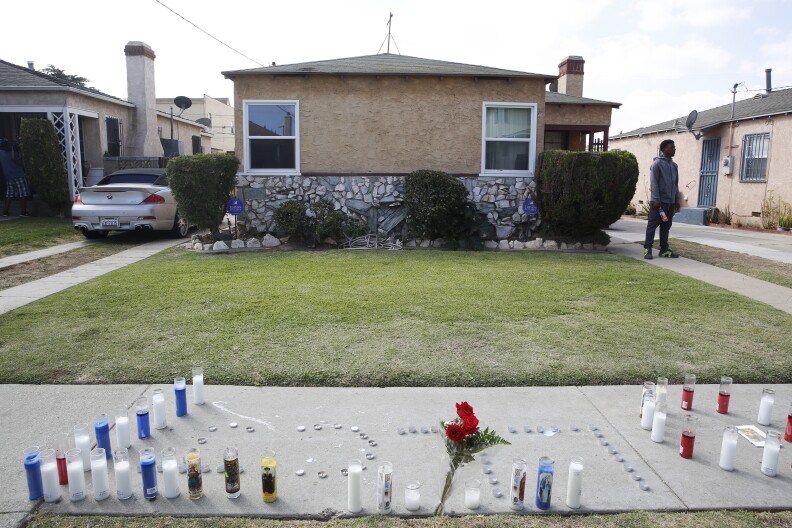 Candles spell out "L.L.C.J." for Long Live C. J., outside a  residence on Sunday, Oct. 2, 2016. Officers shot and killed Carnell Snell Jr. in south Los Angeles on Saturday at the end of a car chase, sparking a protest by several dozen people angered by another fatal police shooting of a black man.