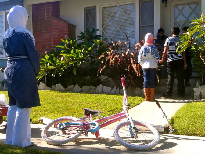  Amy waits as the kids stop at another house.