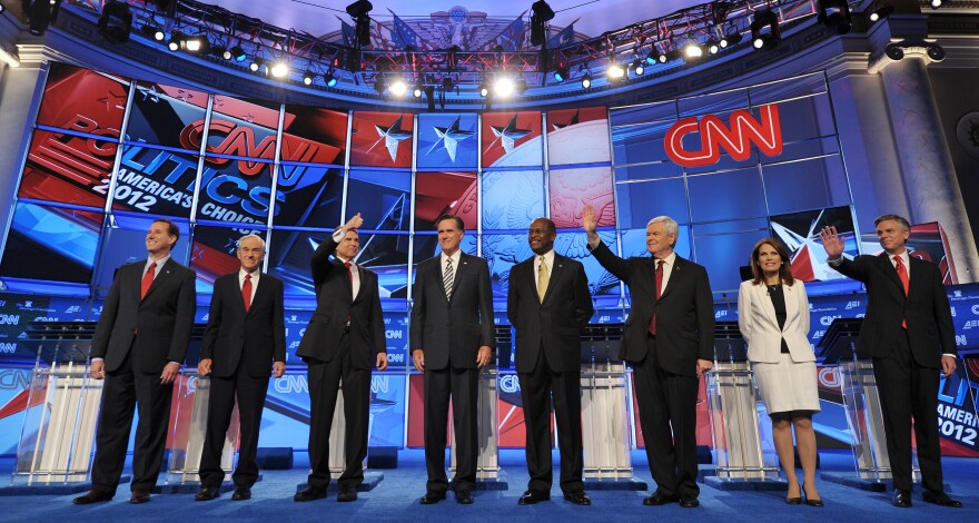 Republican presidential candidates arrive on stage prior to the start of the Republican presidential debate on national security November 22, 2011 at the Daughters of the American Revolution (DAR) Constitution Hall in Washington, DC. The debate is hosted by CNN in partnership with the Heritage Foundation and the American Enterprise Institute. From left are: Former Pennsylvania senator Rick Santorum; Texas Rep. Ron Paul; Texas Gov. Rick Perry; former Massachusetts governor Mitt Romney; businessman Herman Cain; for House speaker Newt Gingrich; Minnesota Rep. Michele Bachmann; and former Utah governor Jon Huntsman. AFP PHOTO / Mandel NGAN (Photo credit should read MANDEL NGAN/AFP/Getty Images)