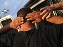 LOS ANGELES, CA - OCTOBER 14:  U.S. Immigration and Customs Enforcement (ICE), agents detain an immigrant on October 14, 2015 in Los Angeles, California. ICE agents said the immigrant, a legal resident with a Green Card, was a convicted criminal and member of the Alabama Street Gang in the Canoga Park area. ICE builds deportation cases against thousands of immigrants living in the United States. Green Card holders are also vulnerable to deportation if convicted of certain crimes. The number of ICE detentions and deportations from California has dropped since the state passed the Trust Act in October 2013, which set limits on California state law enforcement cooperation with federal immigration authorities.  (Photo by John Moore/Getty Images)