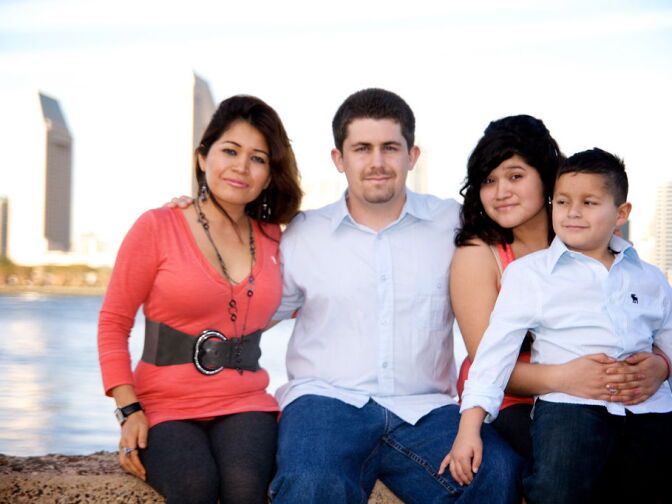 Maythe and T.J. Barbour, married since 2002, sit for a family portrait in San Diego with their two children, Nidia and Lucas.  Maythe was deported in 2011 and barred from entering the U.S. for 20 years. She lives in Tijuana with Nidia. T.J. and Lucas visit on weekends.   