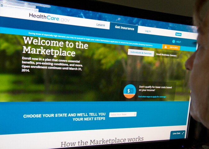 This December 2, 2013 photo shows a woman reading the HealthCare.gov insurance marketplace internet site in Washington, DC.