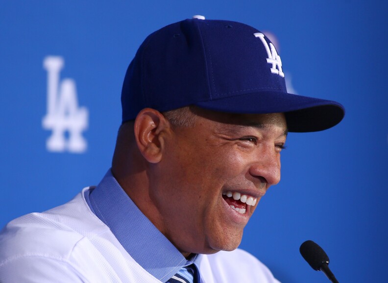 File: Dave Roberts laughs during a press conference to introduce him as the new Los Angeles Dodgers Manager at Dodger Stadium on Dec. 1, 2015 in Los Angeles.