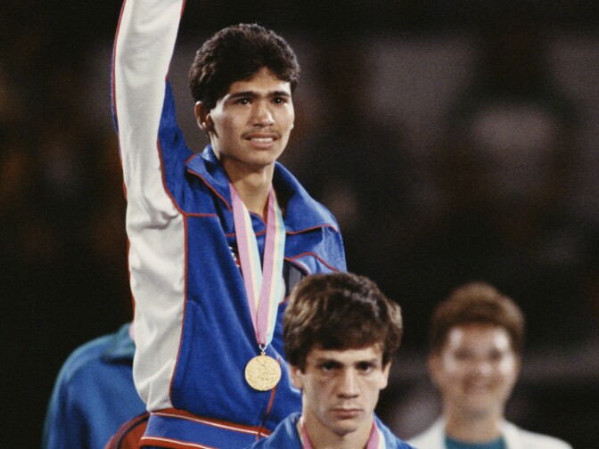 Paul Gonzales Jr of the United States stands above silver medallist Salvatore Todisco of Italy on the podium and celebrates winning the Men's Light-Flyweight Boxing final on 11th August 1984 during the XXIII Olympic Summer Games at the Los Angeles Memorial Sports Arena, Los Angeles, California , United States. (Photo by Getty Images)