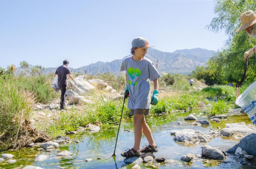 A young volunteer helps clean up the Tujunga Wash during the 2017 Great L.A. River Cleanup, an event founded in 1989 by Friends of the L.A. River.