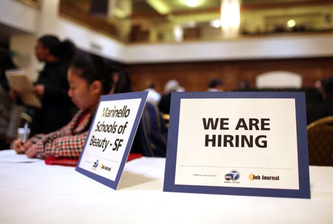 The unemployment rate for Los Angeles County jumped to nearly 10 percent in July. But employment analysts said Friday that's an improvement over 2012. (File photo: A "we are hiring" sign is displayed on a table during a job fair in San Francisco).