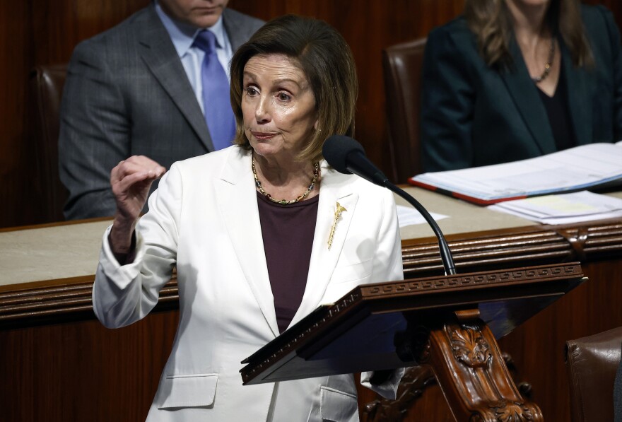 Speaker of the House Nancy Pelosi delivers remarks from the Capitol's House chamber on Nov. 17. She gestures with her right hand and wears a white jacket.