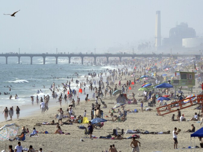 Crowds gather at the beach, Sunday, July 18, 2010, in Hermosa Beach, Calif.  