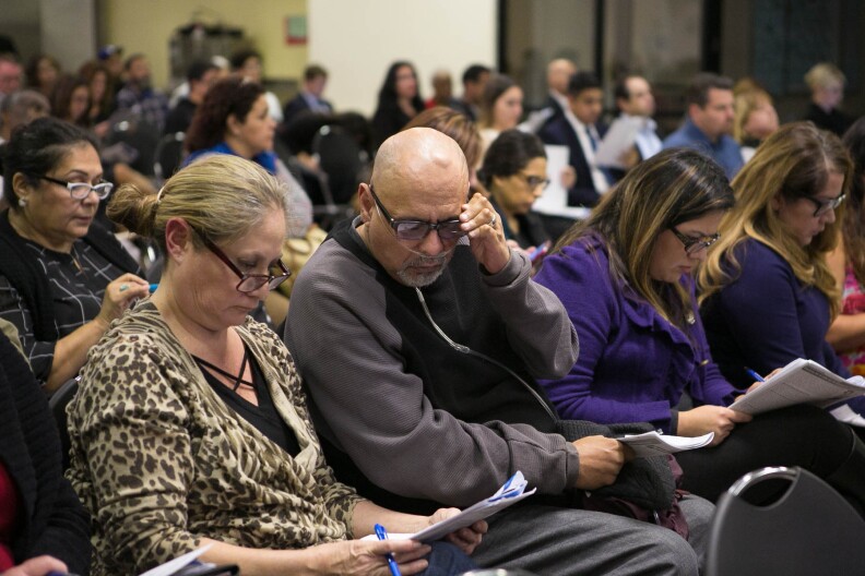 Residents listen at a town hall meeting at the Paramount Community Center hosted by South Coast Air Quality Management District (SCAQMD) and Los Angeles County Department of Public Health to provide the public with information on air monitoring efforts and the investigation of hexavalent chromium sources on Monday, Dec. 12, 2016 in Paramount, Calif.