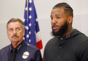 Los Angeles Police Chief Charlie Beck, left, listens as rapper The Game speaks at a news conference following a meeting he and fellow rapper Snoop Dogg had with Beck and Mayor Eric Garcetti at police headquarters in Los Angeles Friday, July 8, 2016. The rappers led a peaceful march where they urged improved relations between police and minority communities in the wake of shootings in Dallas that left five police officers dead.