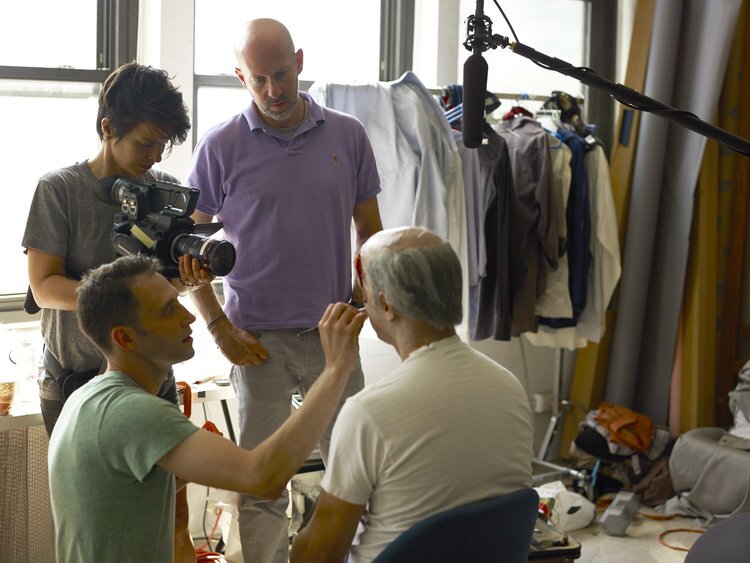 Filmmaker Joshua Seftel (purple shirt) interviews artist Phil Toledano (in make-up chair) on shoot of "The Many Sad Fates of Mr. Toledano"
