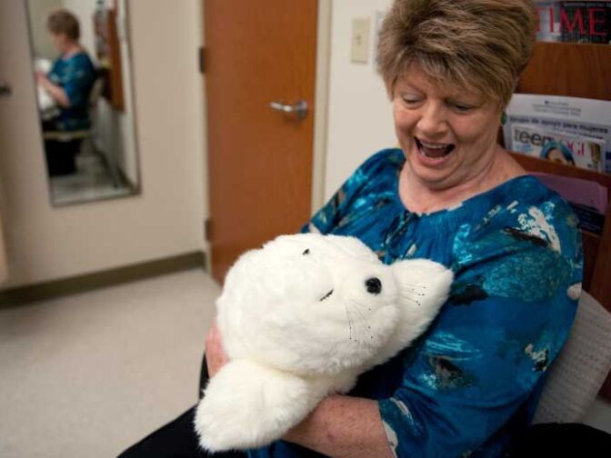 Therapy robot Paro recently accompanied cancer patient Kirsten Osgood, 70, through a 7½-hour chemotherapy session at UC Irvine Medical Center.