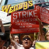 People gathered outside a Wendy's restaurant in New York City on Monday as part of a one-day strike calling for higher wages for fast-food workers.