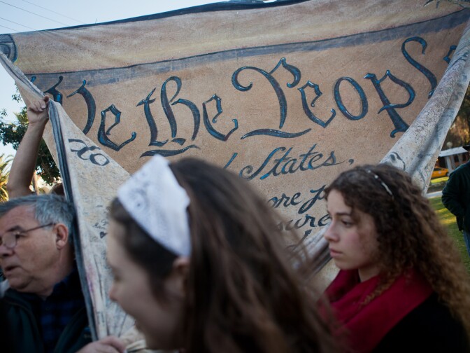 Occupy Rose Parade activist prepared an oversized constitution to care along the Rose Parade route. The prop is filled with scores of signatures from Occupy protesters.