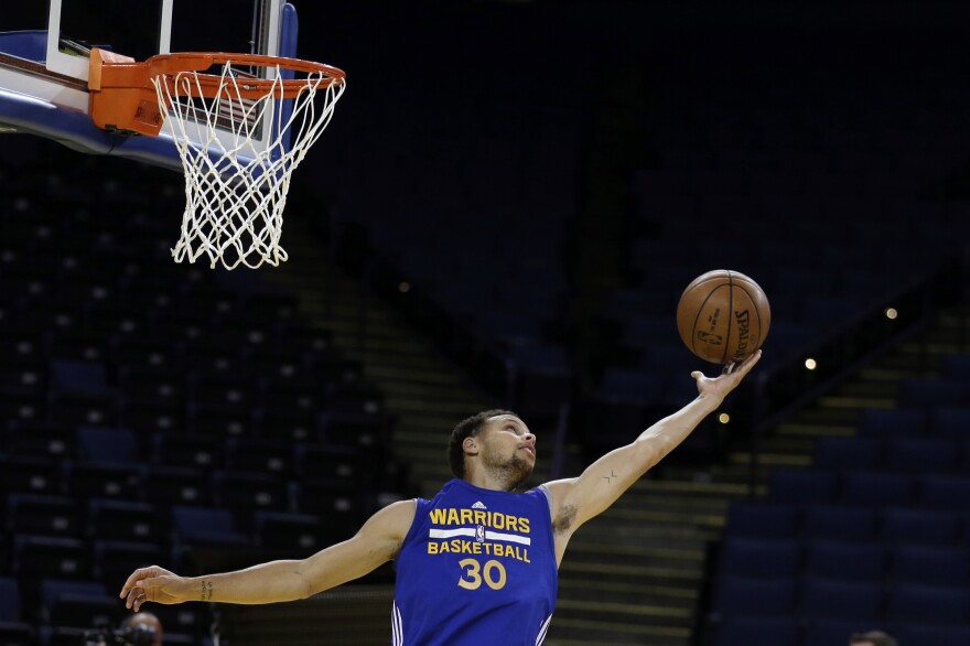 Golden State Warriors' Stephen Curry reaches for the ball during NBA basketball practice, Wednesday, June 3, 2015, in Oakland, Calif. The Warriors host the Cleveland Cavaliers in Game 1 of the NBA Finals on Thursday. (AP Photo/Ben Margot)